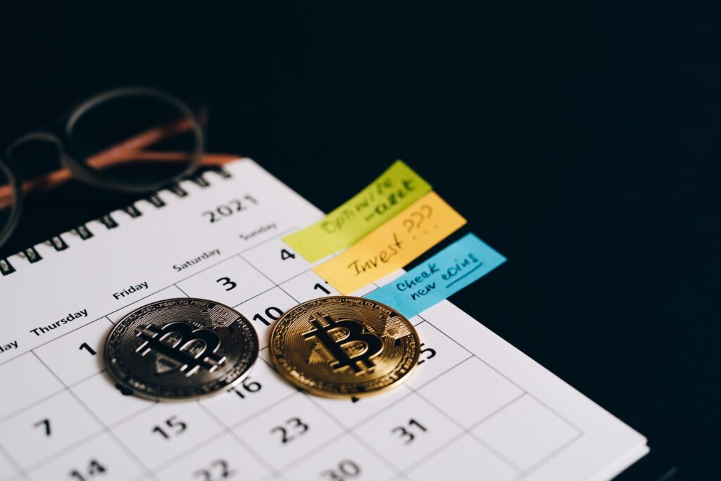 Coins lined up beside a calendar for a weekly saving challenge
