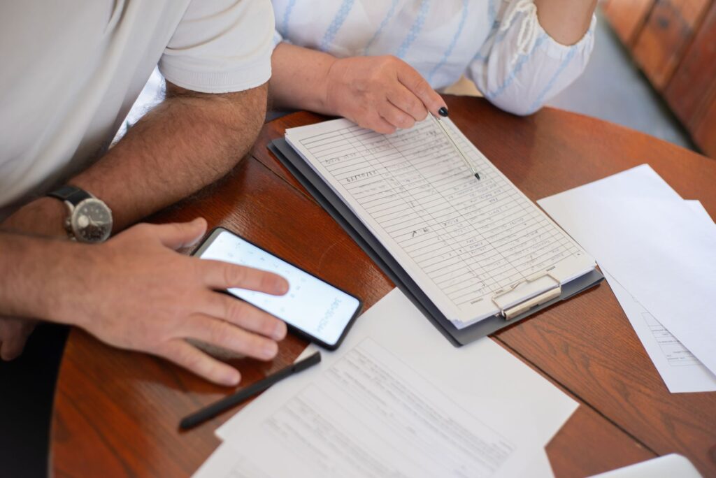 Couple reviewing finances on laptop at kitchen table