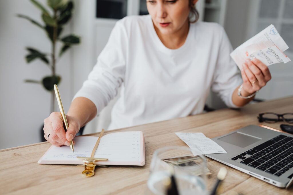A budgeting planner and notebook on a desk