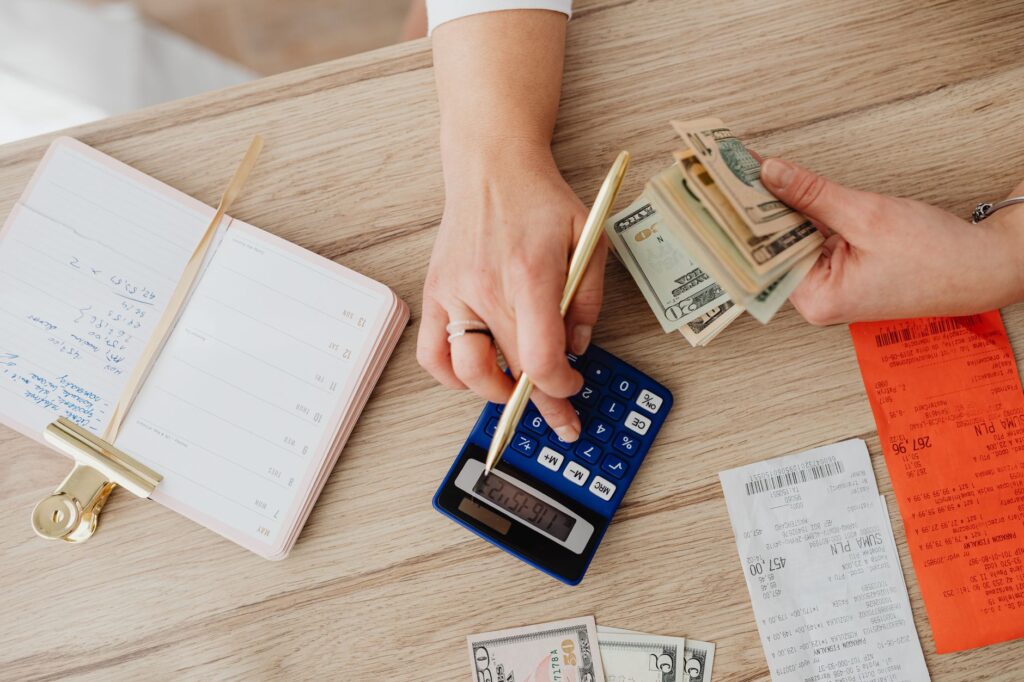 Planning a debt payoff with a calculator and notebook