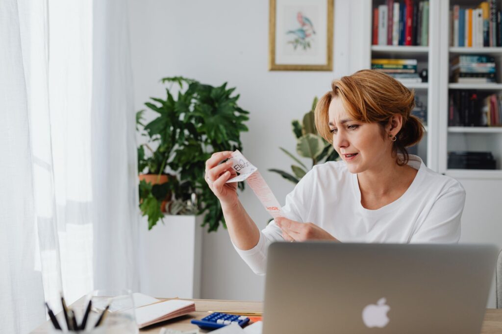 A person reviewing finances to plan debt payoff