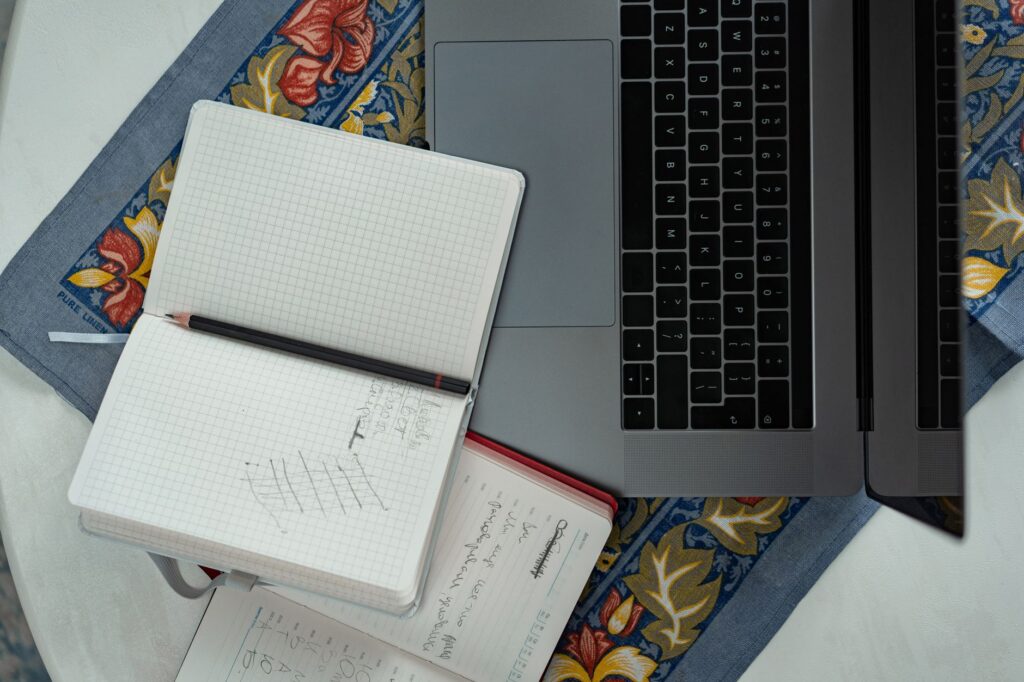 Planning a no-cost side hustle with a laptop and notebook