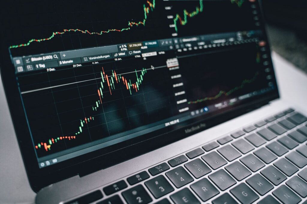 person reviewing investment portfolio growth charts on laptop computer