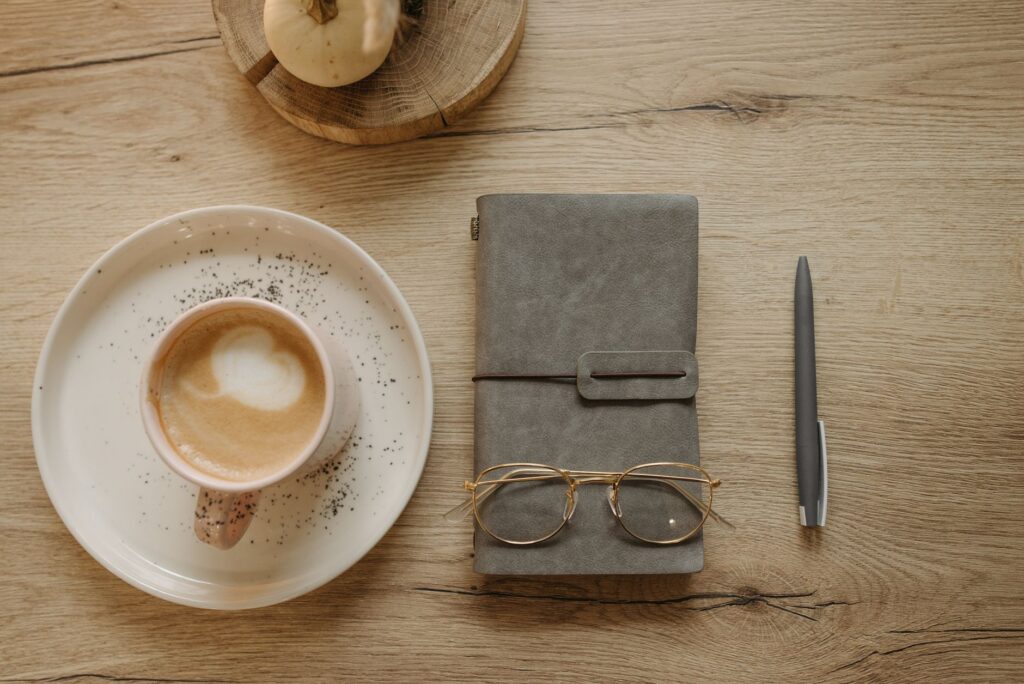 A journal and coffee for reflecting on money mindset
