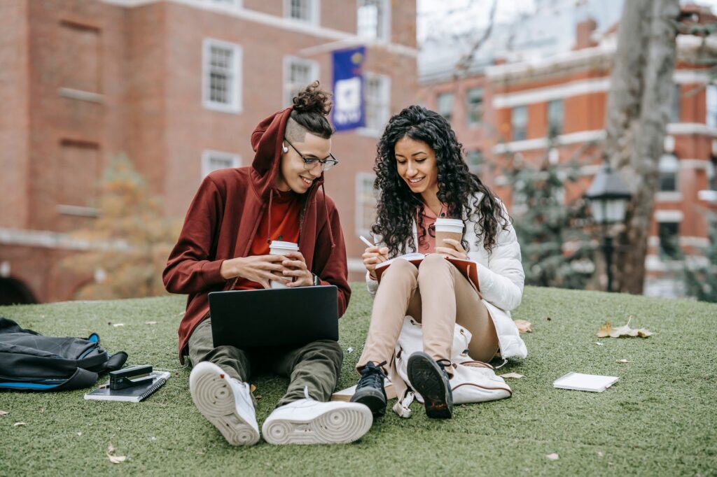 A student working on a laptop between classes