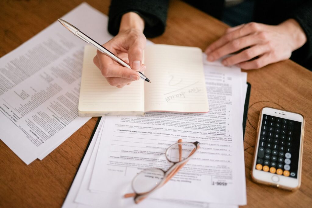 A well-organized desk with a budget notebook, calculator, and financial planning materials