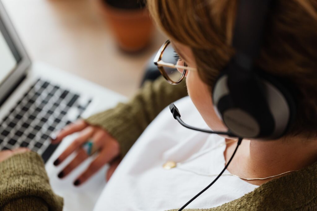 Working on transcription with headphones and a laptop