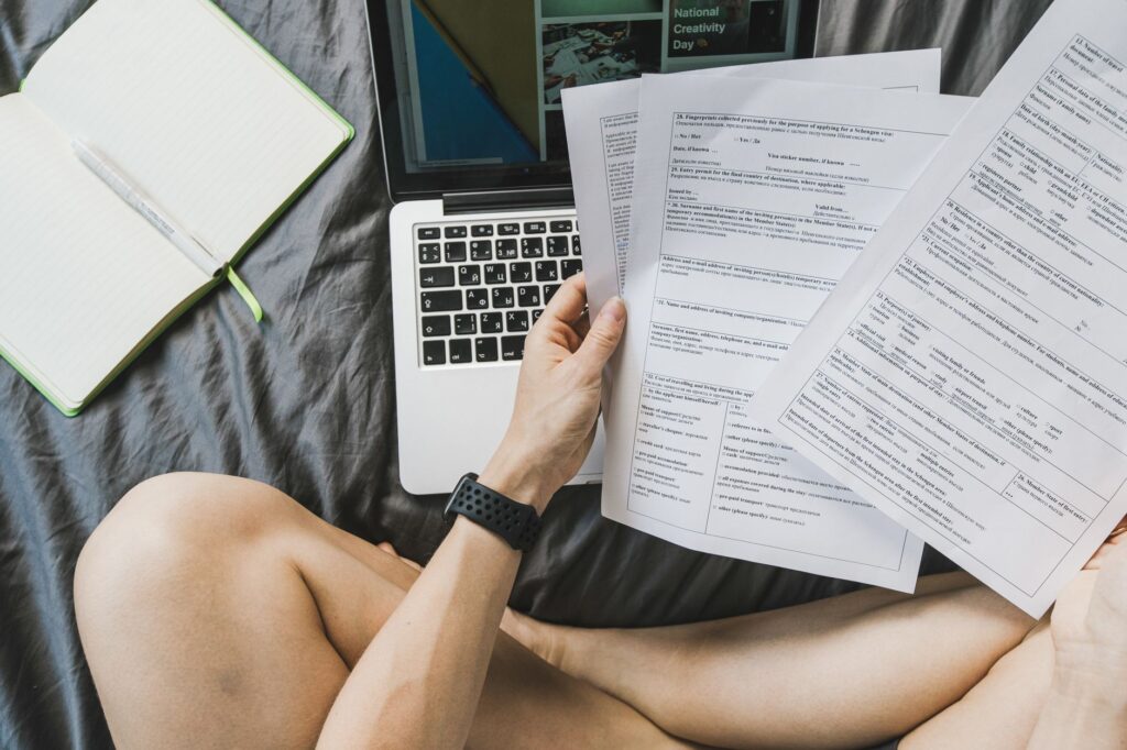 Freelancer reviewing invoices and budget on a laptop at a home desk