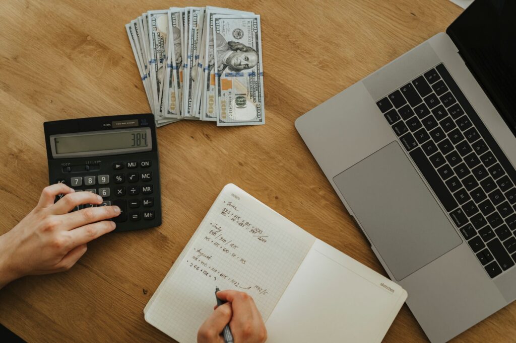 Person reviewing financial plans and savings with a notebook and calculator