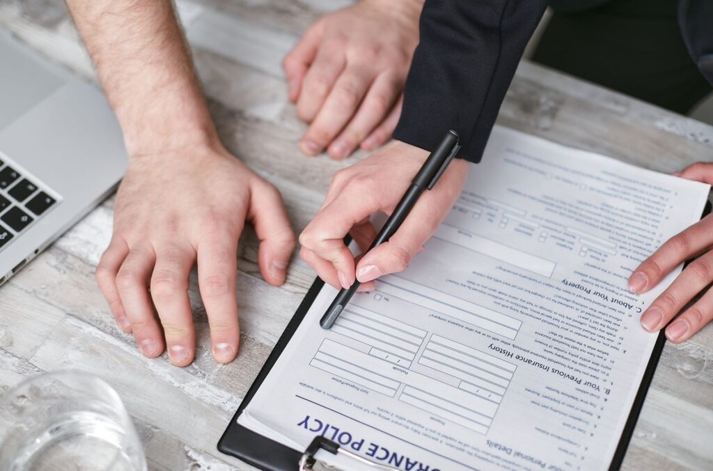 Person reviewing insurance policy documents at a desk