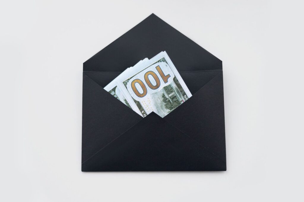 Budget categories organized using labeled envelopes or jars