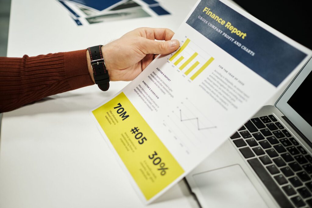 person reviewing a credit report on a laptop at a desk