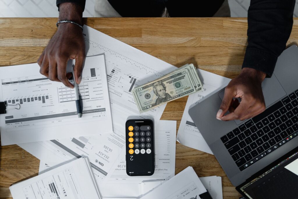 Person reviewing a savings tracker on a laptop at a desk