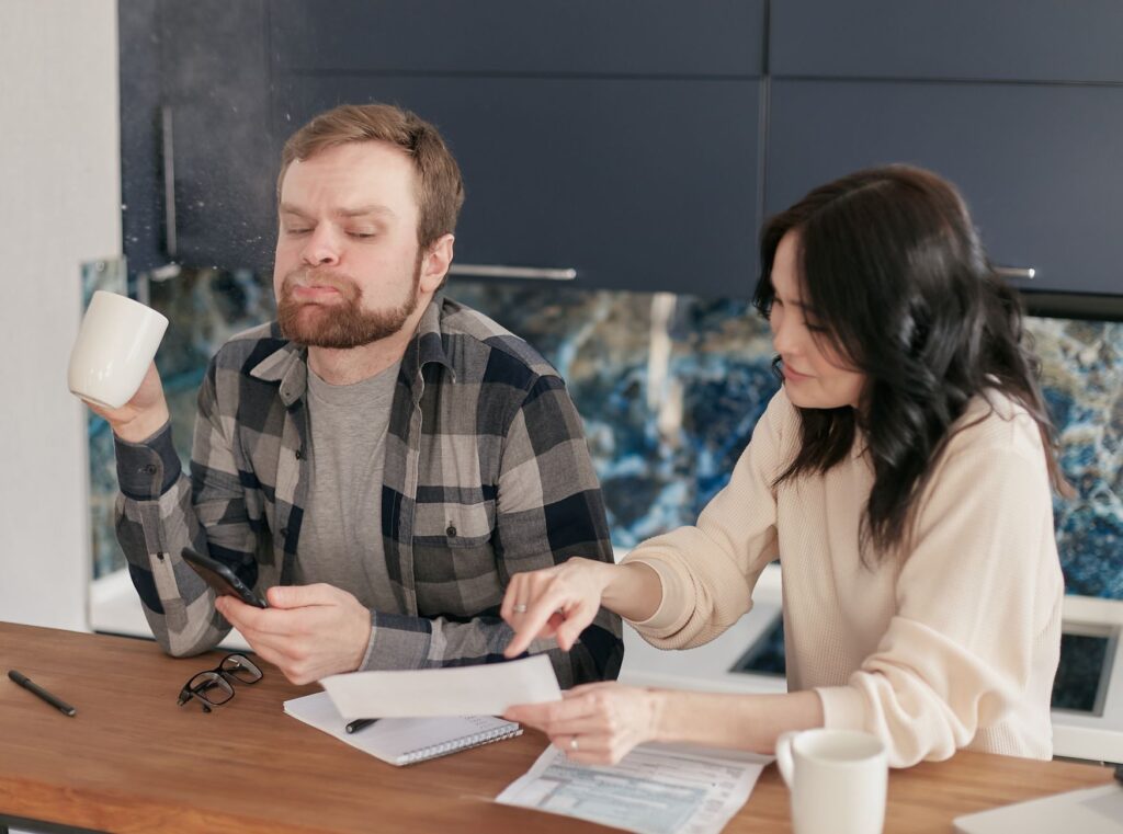 Couple reviewing finances together at the kitchen table