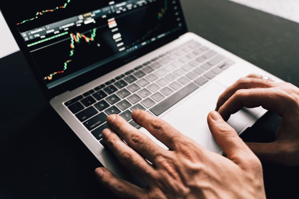 Person reviewing retirement investment portfolio on a laptop