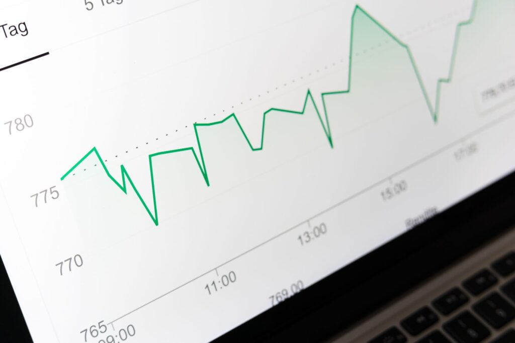 Stock market chart trending upward on a laptop screen