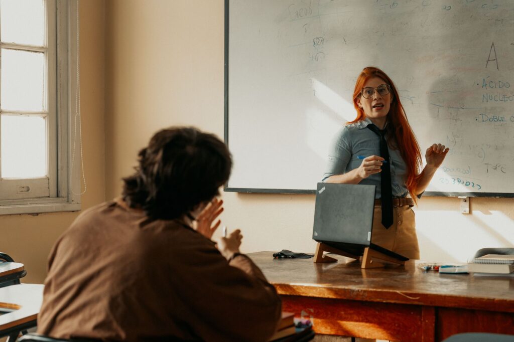 Teacher reviewing retirement account paperwork at a classroom desk
