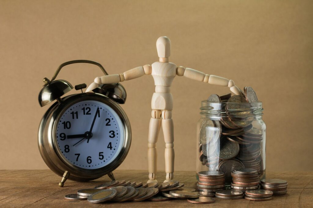 Jar of coins with a small plant growing out of it symbolizing retirement savings growth