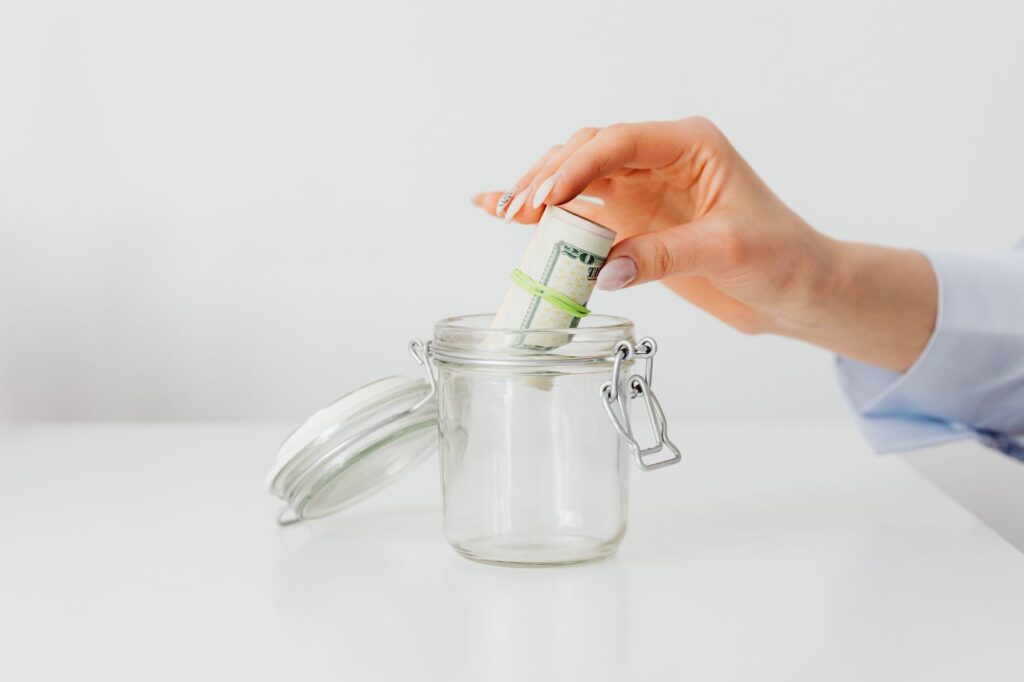 jar and stack of cash representing an emergency fund