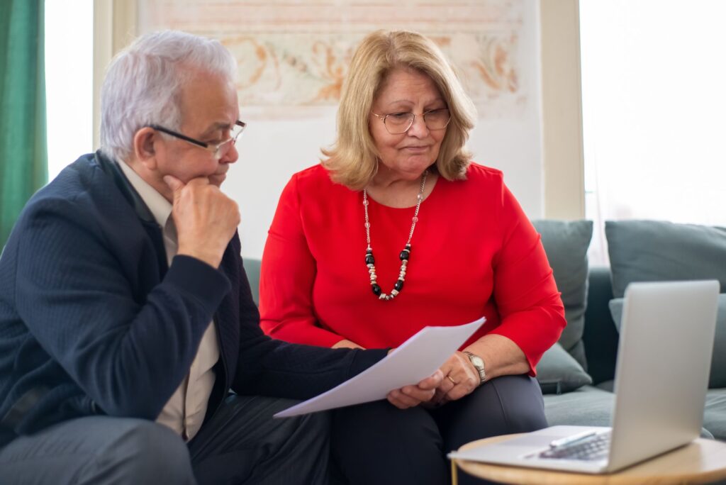 Small business owner reviewing retirement account paperwork at a desk