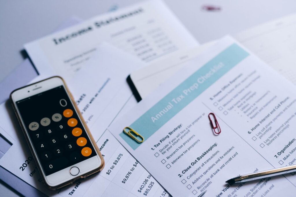 Calculator and tax documents laid out for retirement contribution planning