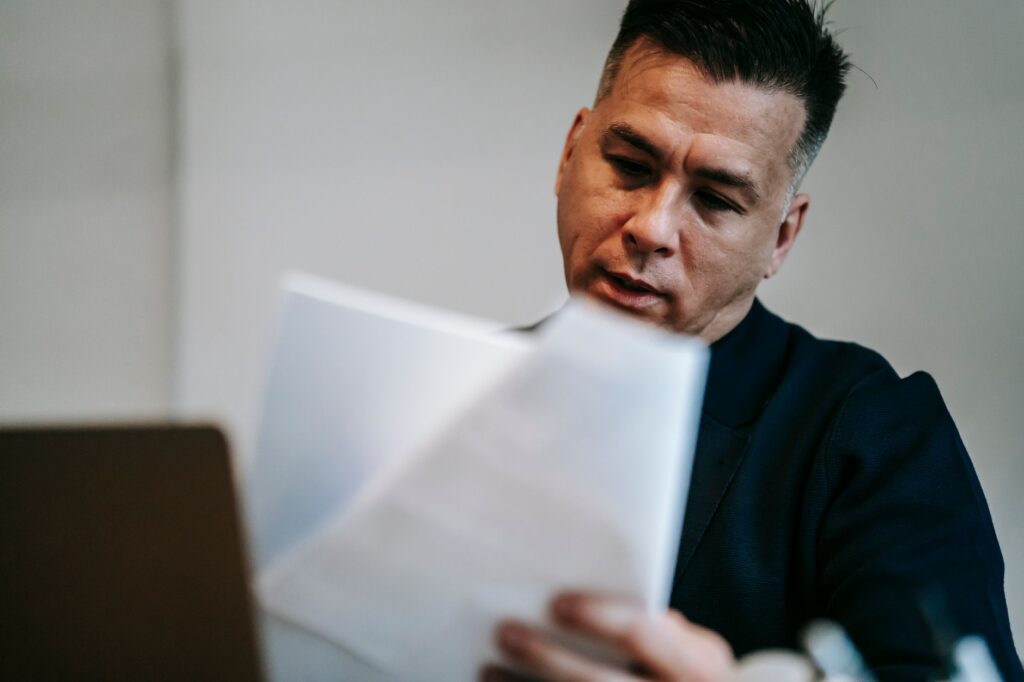 Small business owner reviewing retirement account paperwork at a desk
