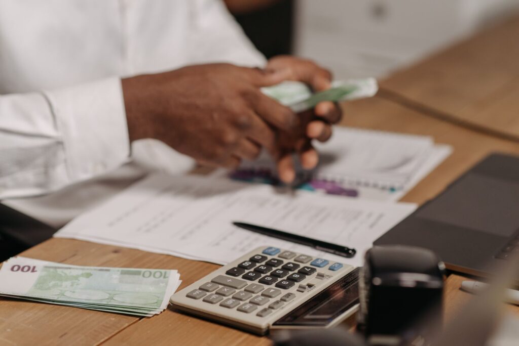Retirement account paperwork and a calculator on a desk