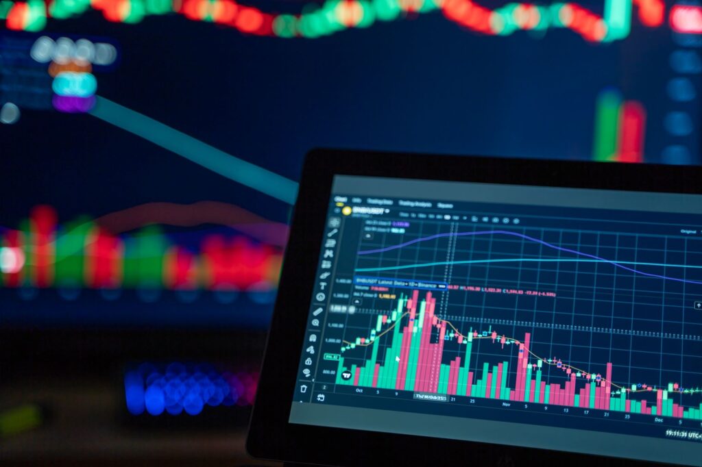 Laptop showing an investment chart with a rising line graph