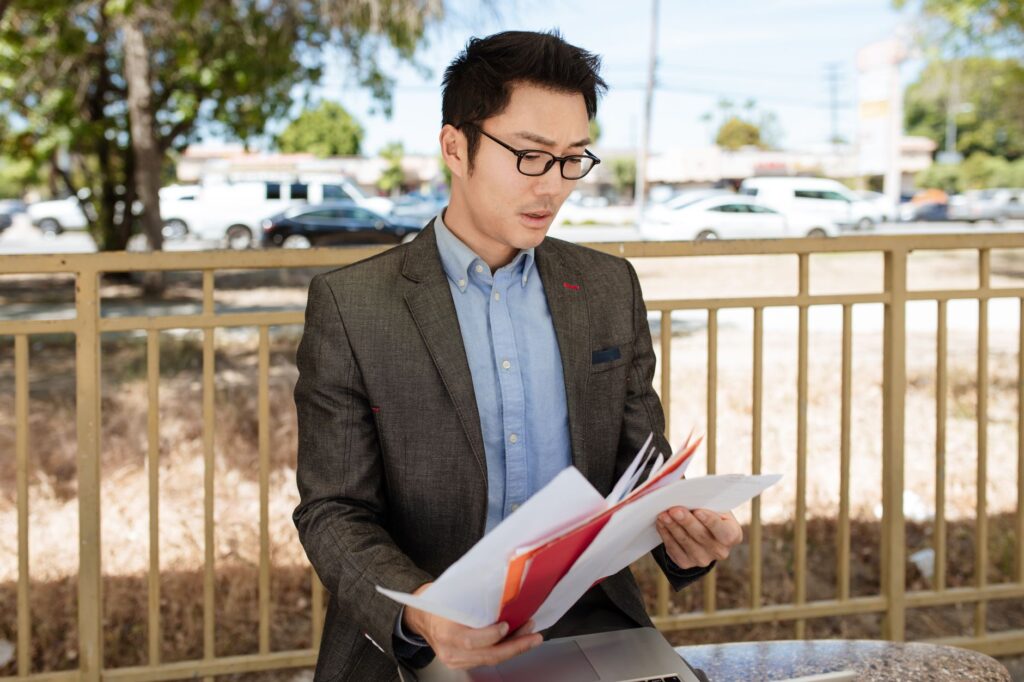 Person carefully reviewing a document on a laptop