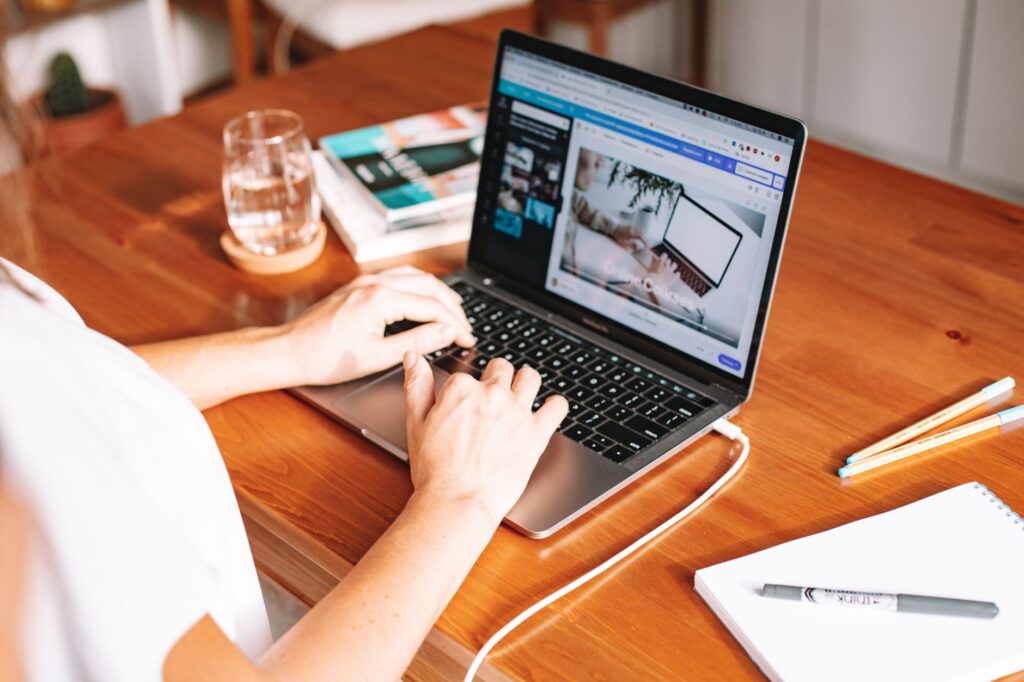 Person working on a laptop at a home office desk