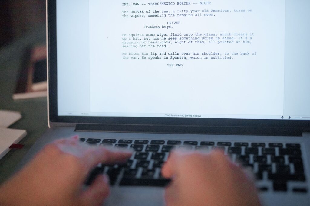 Person reviewing text on a laptop screen